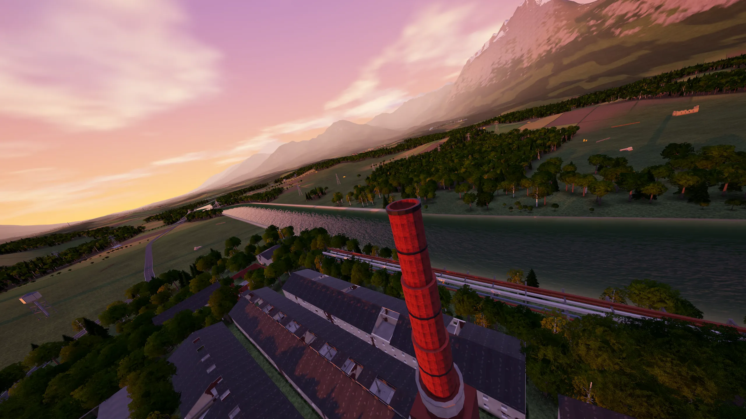 The mill chimney at sunset, the river and mountains behind